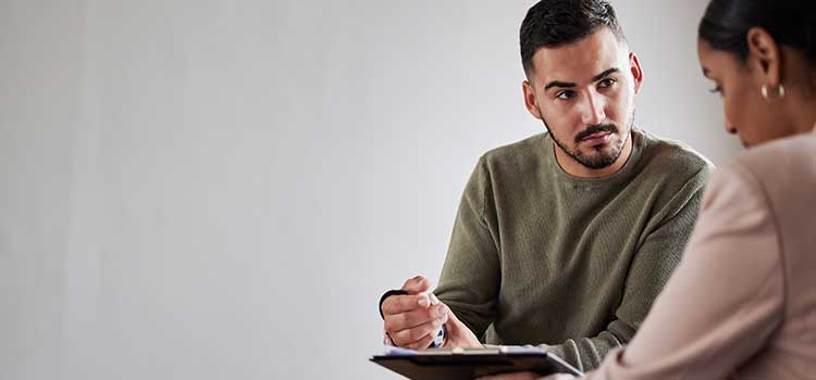 man working with woman on certification exam